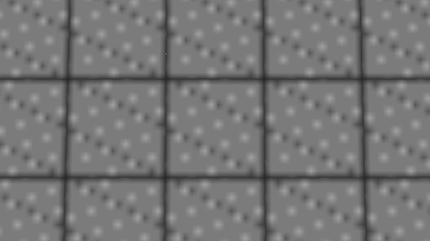 Straight-down nadir view onto a grid of stone block tops with speckled texture and dark seams